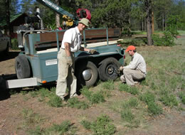 Teaching is an important component of field work; with James Mayer (UA Geosciences PhD, 2009) instructing in the finer points of tire changing.